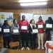 Grupo de haitianos residentes en la comuna de Castro, recibieron certificación de taller de alfabetización